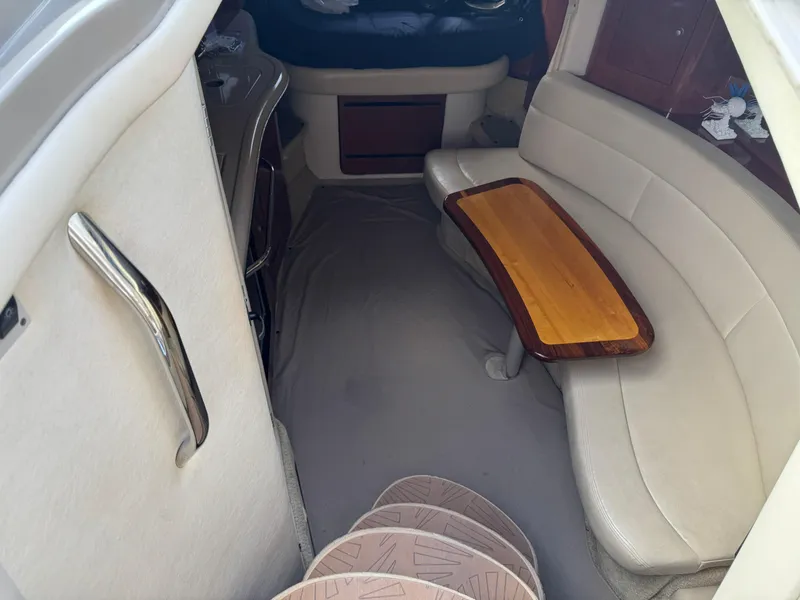 Slide: The Image of Interior of 2006 Sea Ray 320 Sundancer V-Drive with curved seating and wooden table. - 27