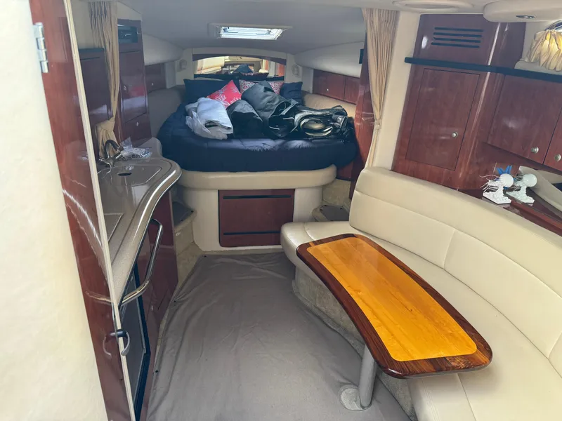 Slide: The Image of Luxurious interior of 2006 Sea Ray 320 Sundancer V-Drive with cozy seating and elegant wood finishes. - 31