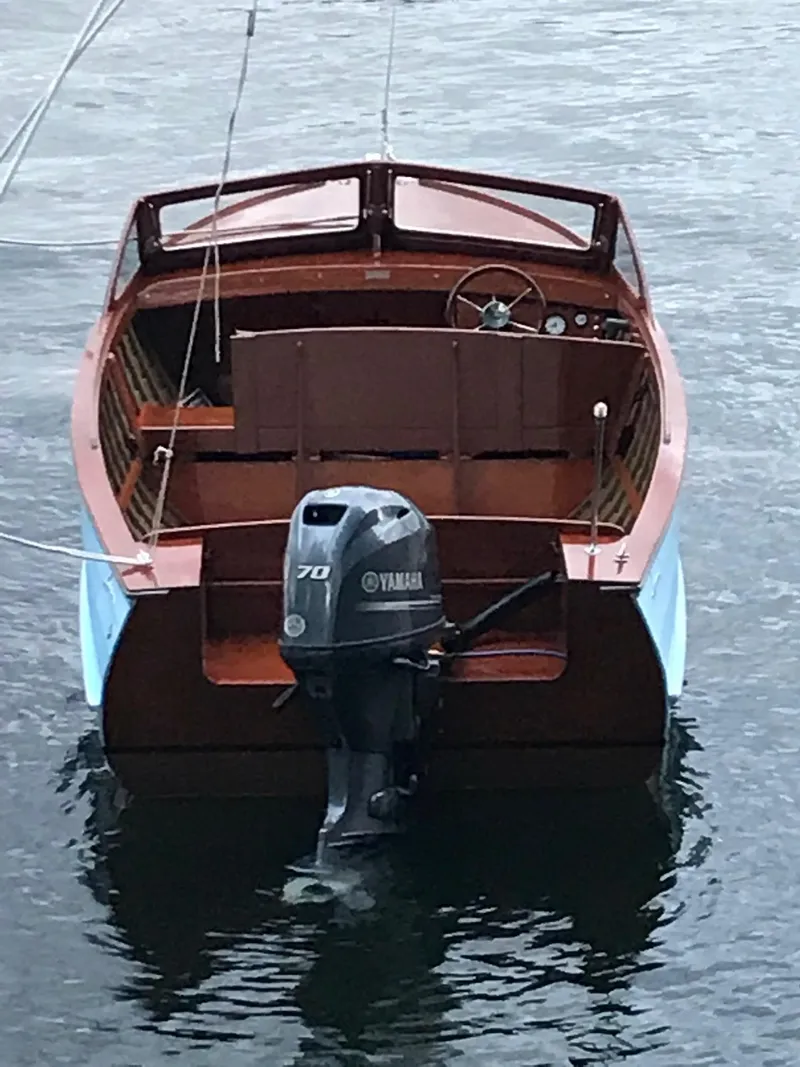 Slide: The Image of 1956 Lyman 18 Outboard boat with Yamaha motor on calm water. - 10