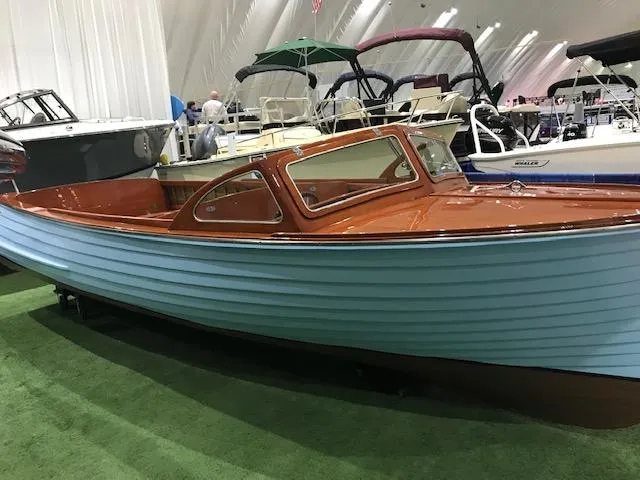 Slide: The Image of 1956 Lyman 18 Outboard boat with wooden finish displayed indoors. - 4