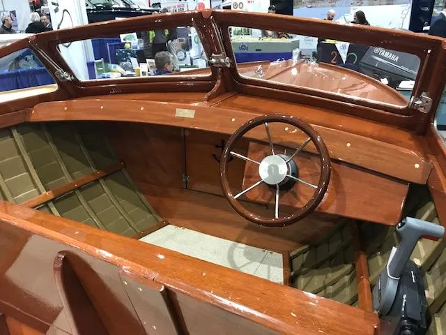 Slide: The Image of 1956 Lyman 18 Outboard boat interior with wooden steering wheel and classic design. - 6