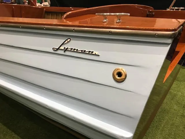 Slide: The Image of 1956 Lyman 18 Outboard boat with polished wood finish and classic design. - 9