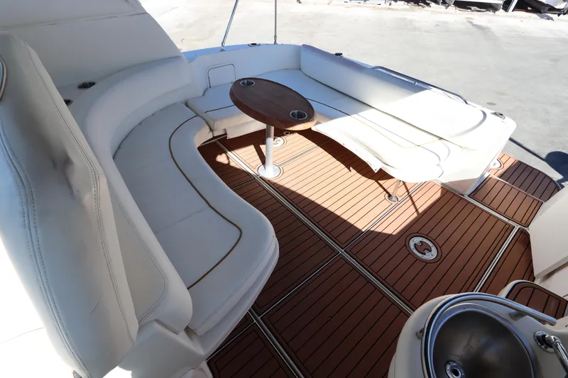 Slide: The Image of 2001 Sea Ray 310 Sundancer boat interior with white seating and wooden deck. - 11
