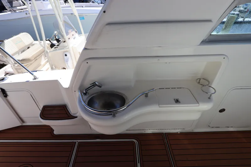 Slide: The Image of 2001 Sea Ray 310 Sundancer boat sink and deck area. - 12