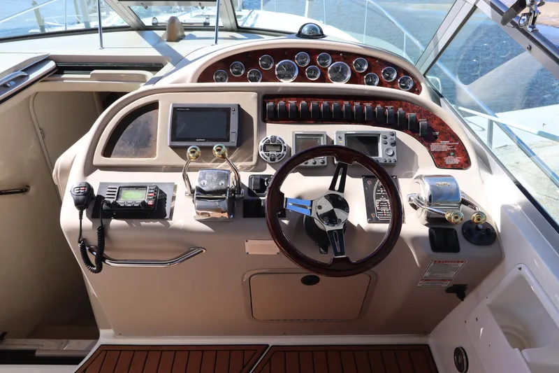 Slide: The Image of Cockpit of 2001 Sea Ray 310 Sundancer with steering wheel and navigation instruments. - 16
