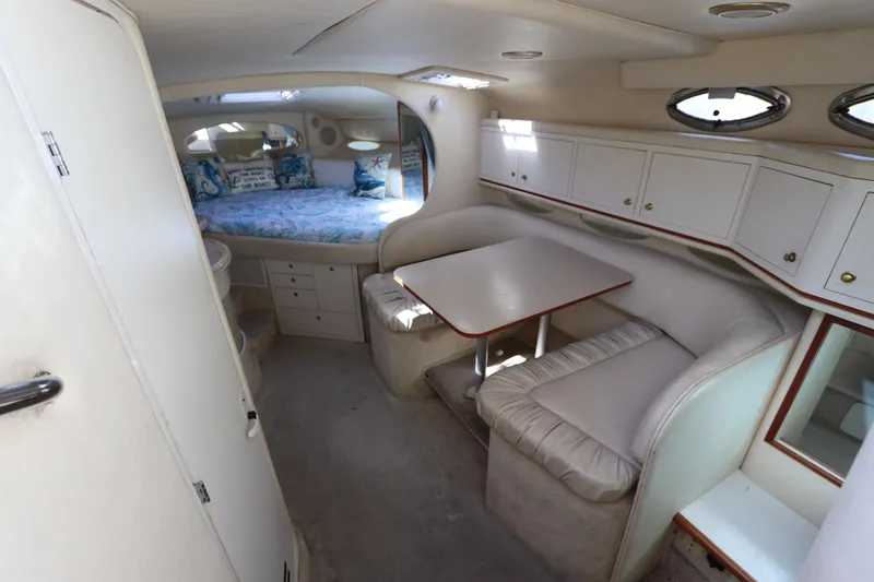 Slide: The Image of Interior of 2001 Sea Ray 310 Sundancer with cozy seating and sleeping area. - 18