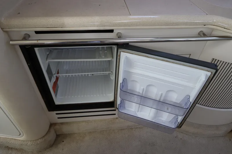 Slide: The Image of Open mini fridge on 2001 Sea Ray 310 Sundancer boat. - 22