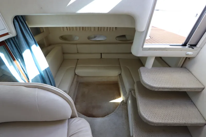Slide: The Image of Interior of 2001 Sea Ray 310 Sundancer with beige seating and steps. - 26