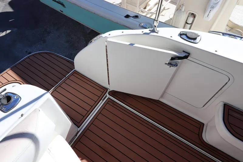 Slide: The Image of Sea Ray 310 Sundancer 2001 boat deck with wood flooring and white cabinetry. - 6