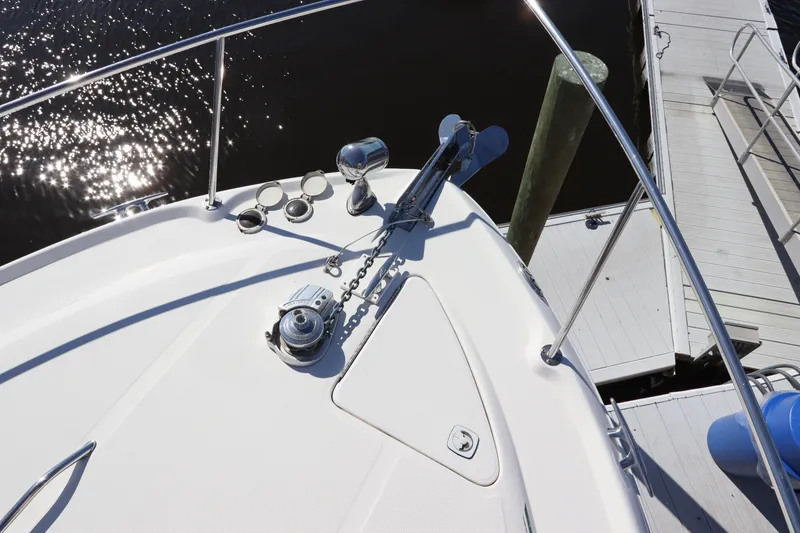 Slide: The Image of 2001 Sea Ray 310 Sundancer boat bow with anchor and dock view. - 8