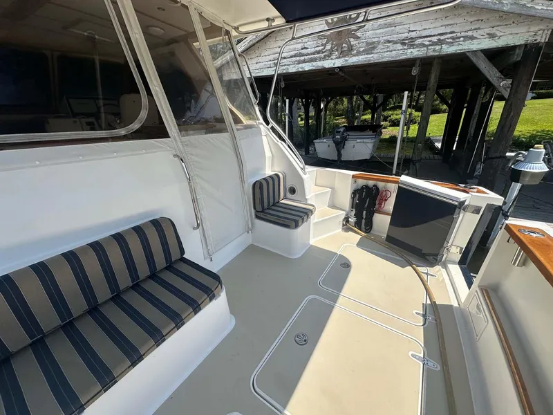Slide: The Image of 2005 Sabre 42 Express boat interior with striped seating and spacious deck area. - 10