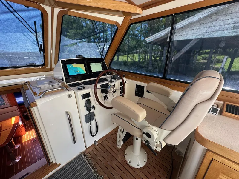 Slide: The Image of 2005 Sabre 42 Express helm with navigation screens and captain's chair. - 12