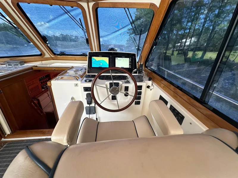 Slide: The Image of 2005 Sabre 42 Express helm with navigation screens and leather seating. - 13