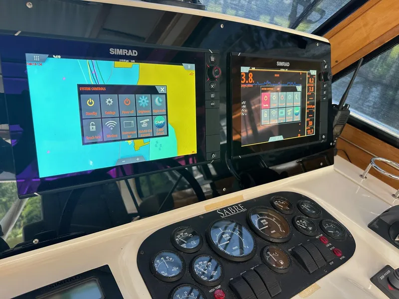 Slide: The Image of Control panel of 2005 Sabre 42 Express with Simrad navigation displays. - 14