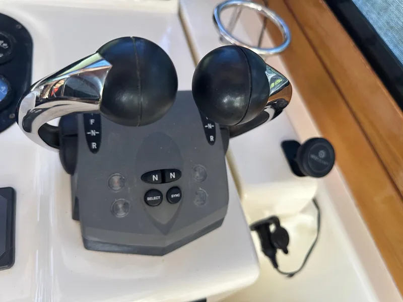 Slide: The Image of Throttle controls on a 2005 Sabre 42 Express boat dashboard. - 16