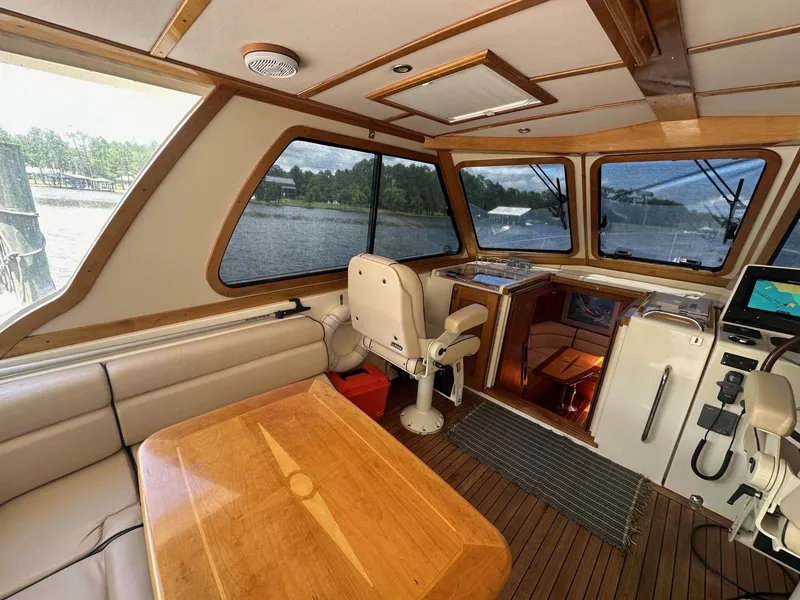 Slide: The Image of Interior of 2005 Sabre 42 Express yacht with wood accents and panoramic windows. - 17