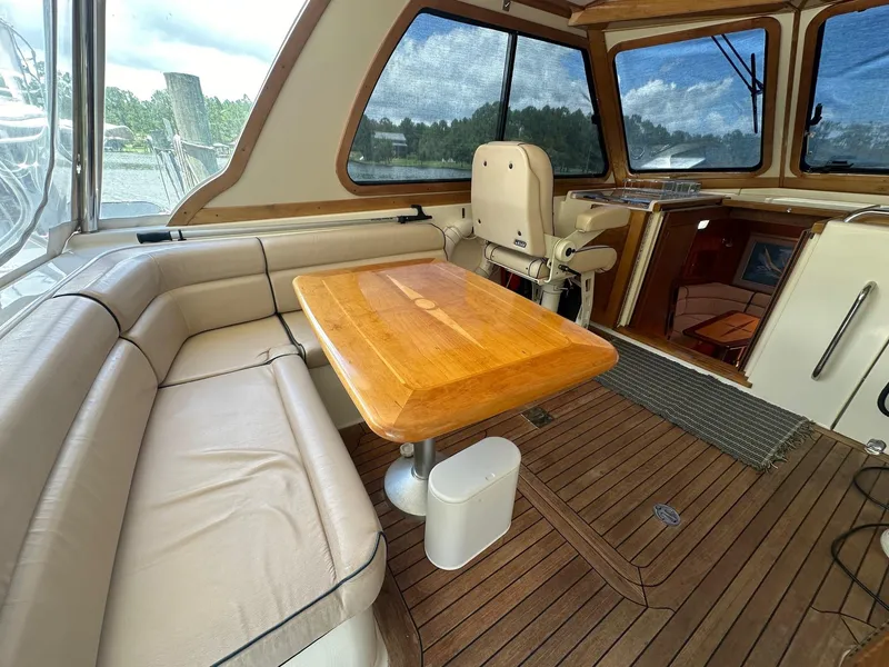 Slide: The Image of Interior of 2005 Sabre 42 Express yacht with wooden table and leather seating. - 18