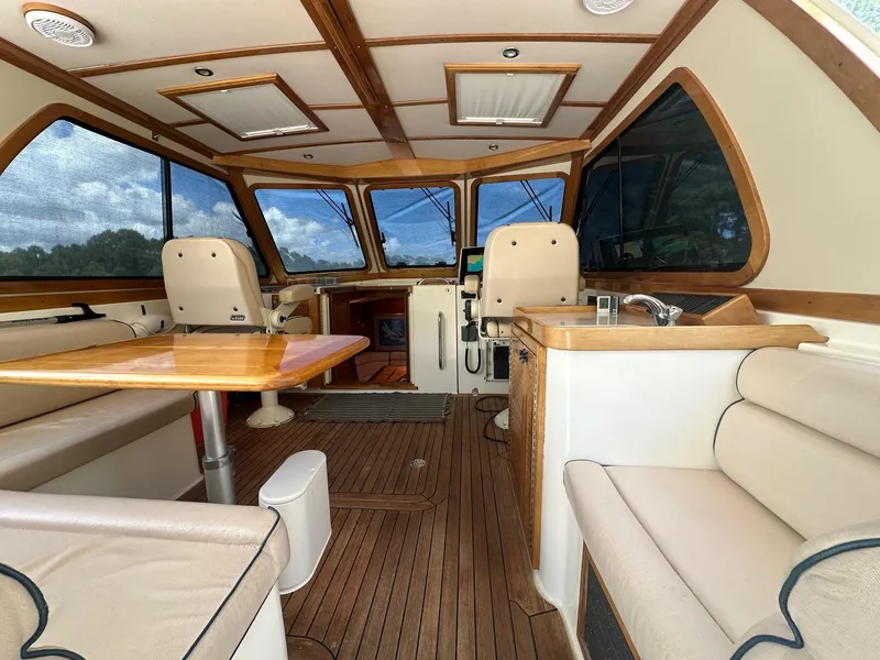 Slide: The Image of Interior of 2005 Sabre 42 Express yacht with wood accents and seating. - 19