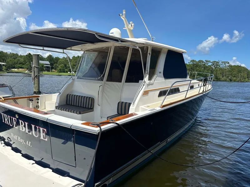 Slide: The Image of 2005 Sabre 42 Express yacht docked on a sunny day, featuring sleek design and spacious deck. - 21