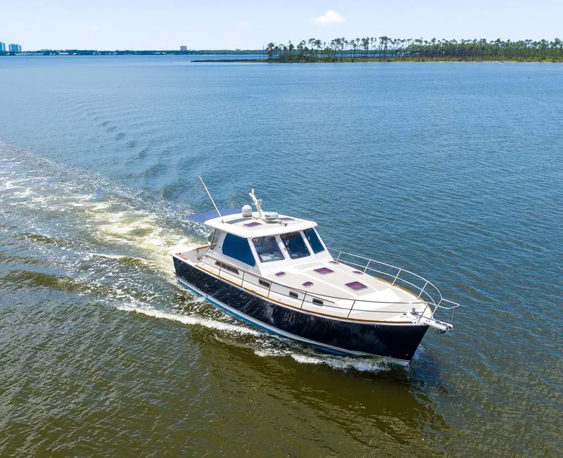 Slide: The Image of 2005 Sabre 42 Express yacht cruising on open water. - 28