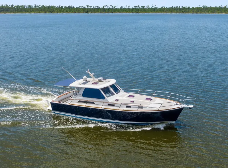 Slide: The Image of 2005 Sabre 42 Express yacht cruising on a calm lake. - 29