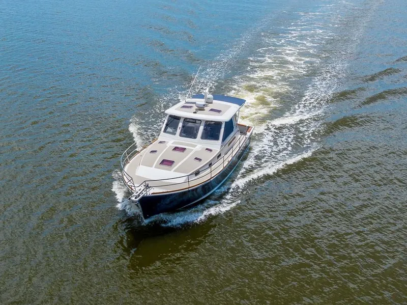 Slide: The Image of 2005 Sabre 42 Express yacht cruising on open water. - 30