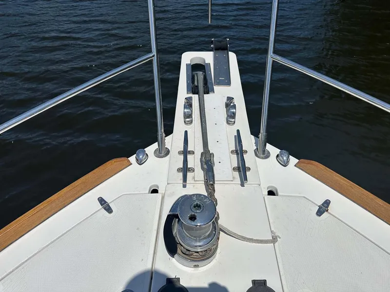 Slide: The Image of Bow of 2005 Sabre 42 Express yacht with anchor winch and railing. - 5