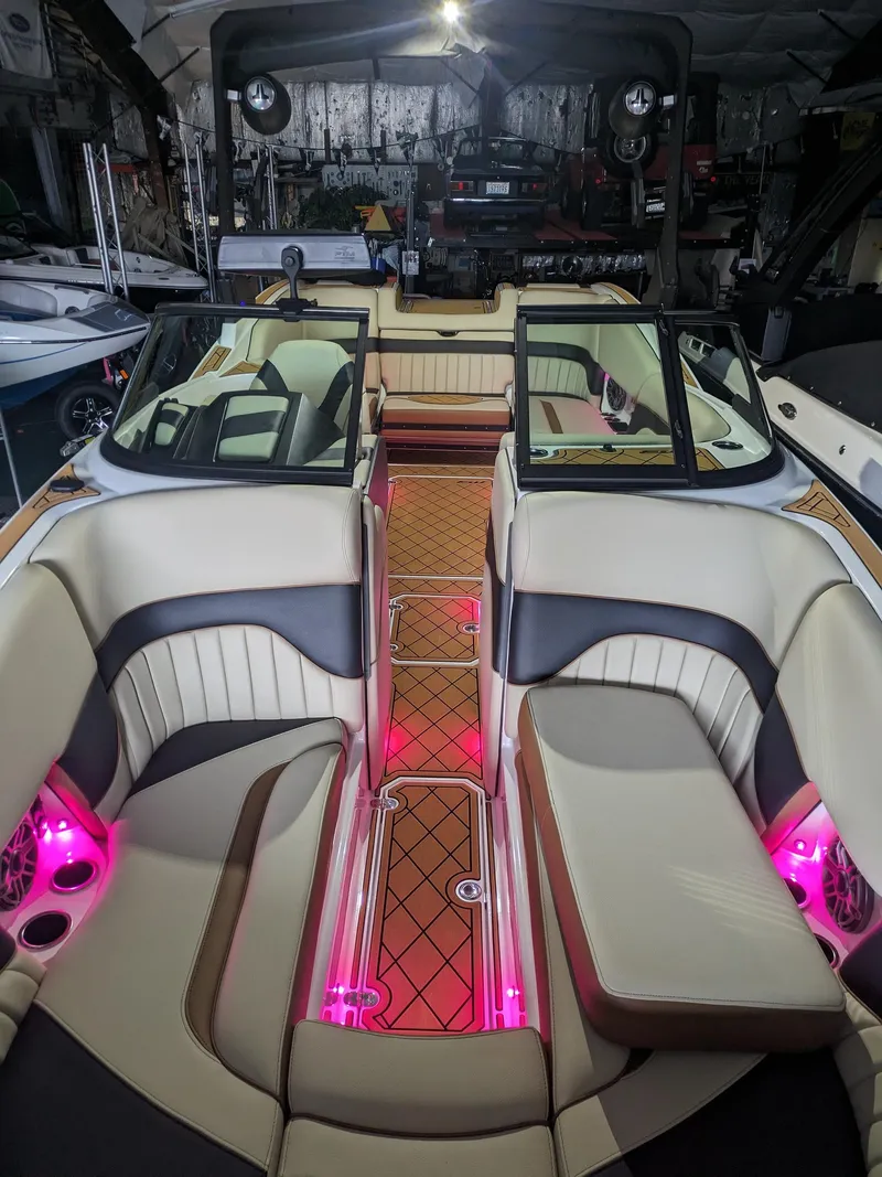 Slide: The Image of 2025 MB B52 25 Alpha boat interior with pink LED lighting and luxurious seating. - 12