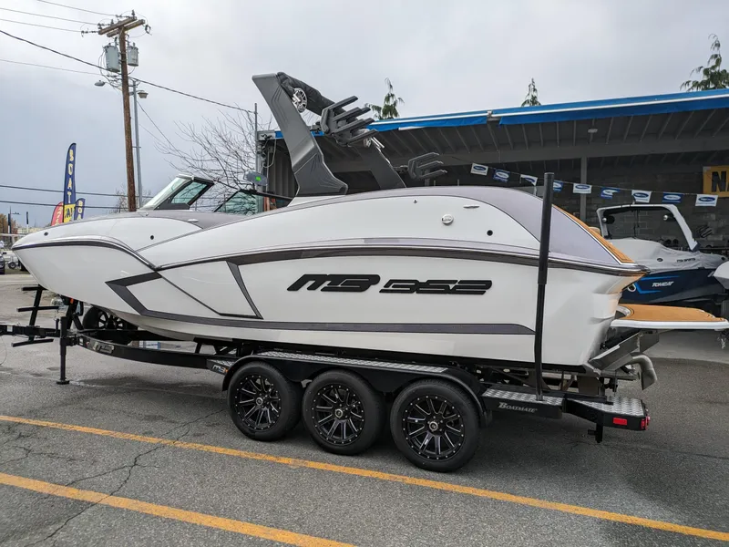 Slide: The Image of 2025 MB B52 25 Alpha boat on trailer, parked outdoors. - 2