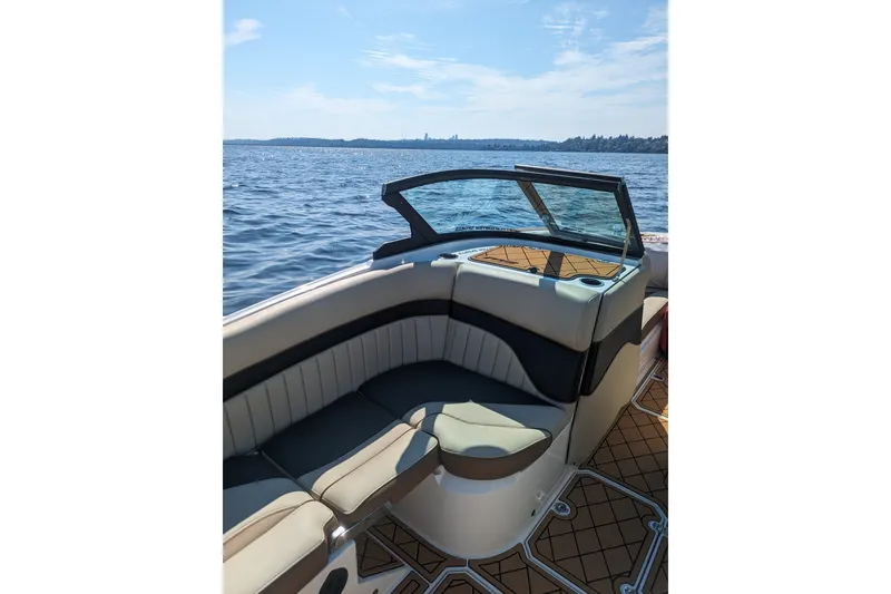 Slide: The Image of 2025 MB B52 25 Alpha boat interior with luxurious seating on a sunny day. - 22