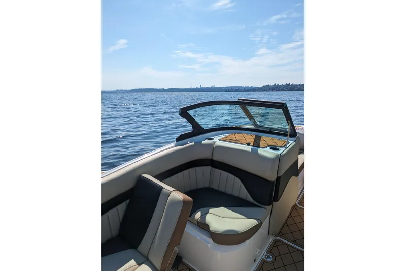 Slide: The Image of 2025 MB B52 25 Alpha boat interior with lake view under clear blue sky. - 23