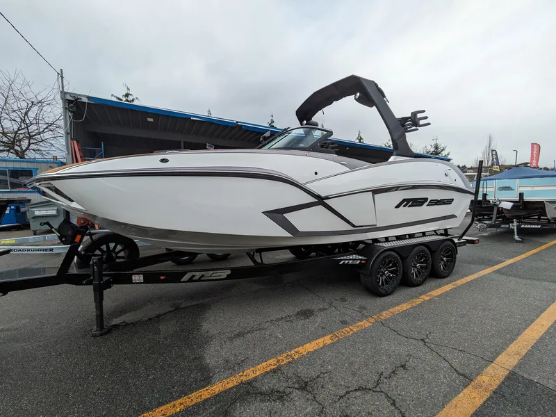 Slide: The Image of 2025 MB B52 25 Alpha boat on trailer, sleek design, parked outdoors. - 6