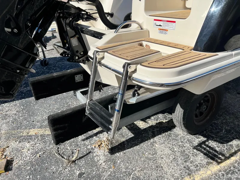 Slide: The Image of 2024 Scout 215 XSF boat with swim platform and ladder. - 11