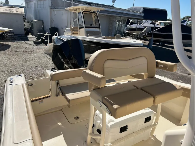 Slide: The Image of 2024 Scout 215 XSF boat interior with seating and storage, displayed outdoors. - 3