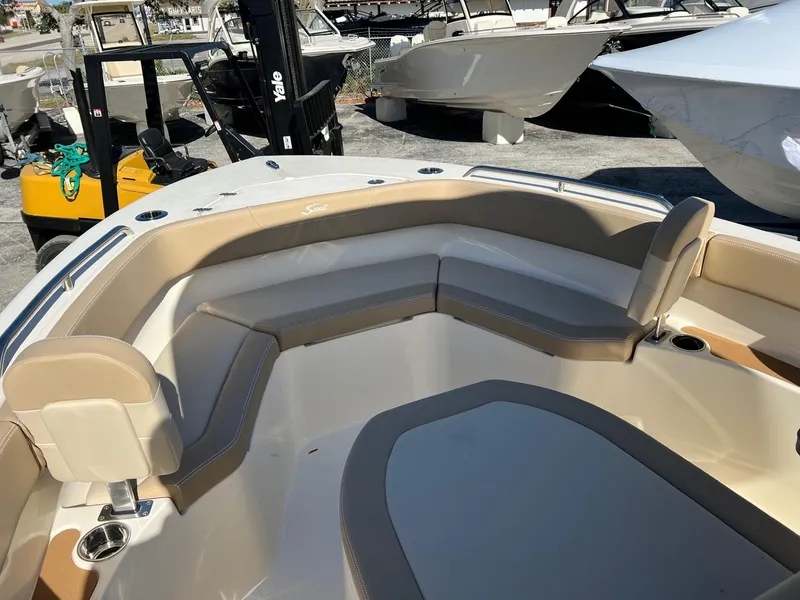 Slide: The Image of 2024 Scout 215 XSF boat interior with beige seating and modern design. - 7