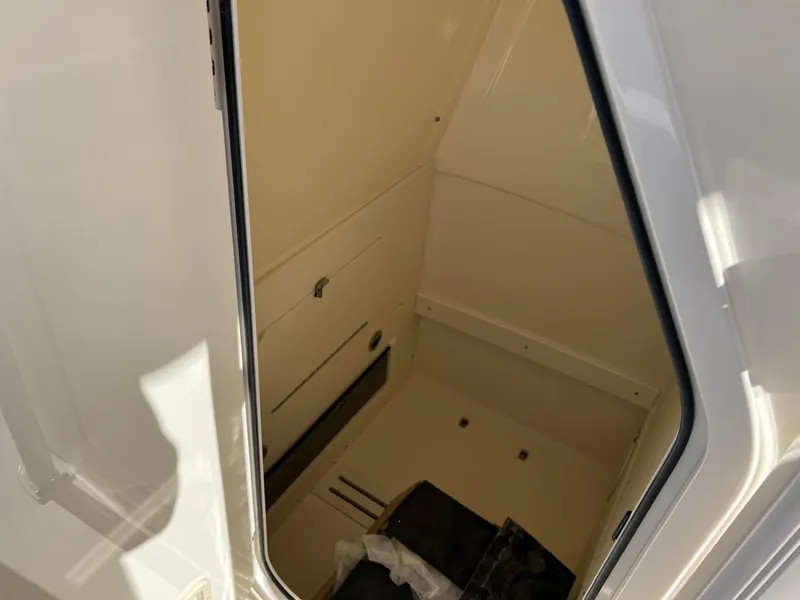 Slide: The Image of 2024 Scout 215 XSF boat interior storage compartment. - 9