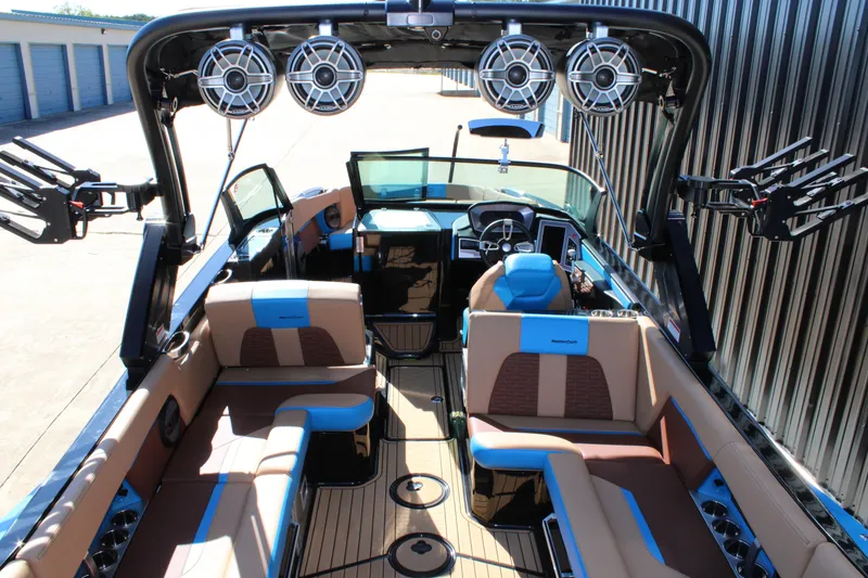 Slide: The Image of 2023 MasterCraft X26 boat interior with luxury seating and advanced audio system. - 10