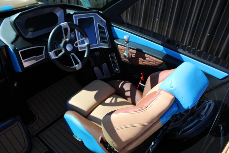 Slide: The Image of 2023 MasterCraft X26 boat interior with modern steering and blue-brown seating. - 18