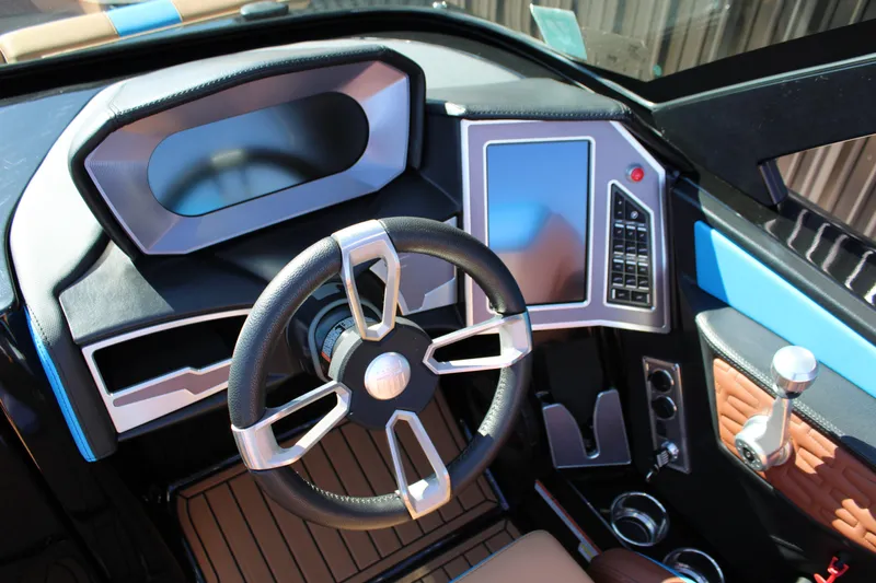Slide: The Image of 2023 MasterCraft X26 boat dashboard with modern steering wheel and touchscreen controls. - 20