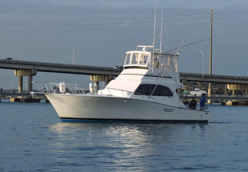 Slide: The Image of 1990 Post 44 yacht cruising near a bridge on calm waters. - 0