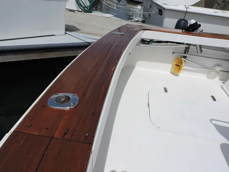 Slide: The Image of 1990 Post 44 boat deck with wooden railing and clean white interior. - 13