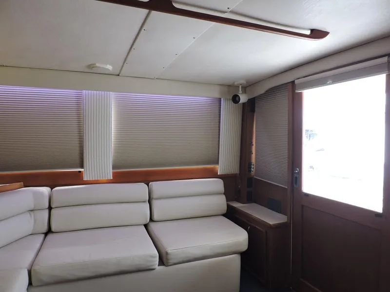 Slide: The Image of Interior of 1990 Post 44 yacht with white seating and wooden accents. - 22