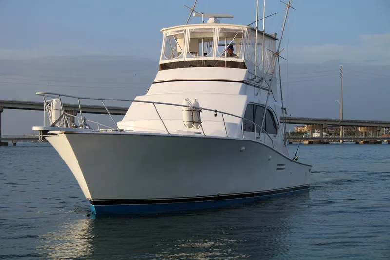 Slide: The Image of 1990 Post 44 yacht cruising on calm waters near a bridge. - 3