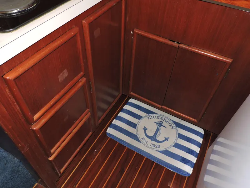 Slide: The Image of Wooden boat interior with striped nautical mat, Post 44 model, 1990. - 31
