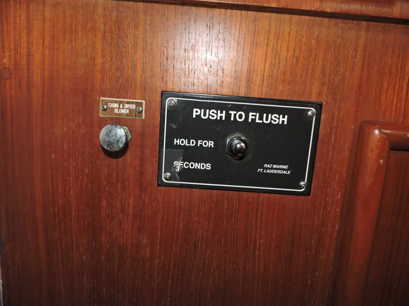 Slide: The Image of 1990 Post 44 boat flush control panel with push button and instructions. - 45