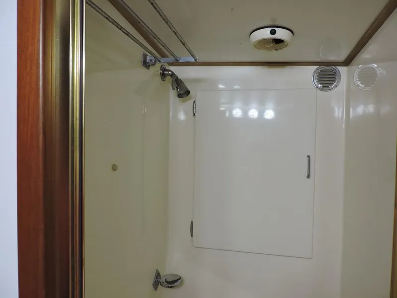 Slide: The Image of Shower area in 1990 Post 44 model boat with white walls and fixtures. - 48