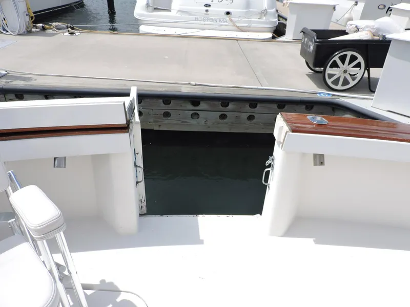 Slide: The Image of 1990 Post 44 boat stern view at marina with open transom door. - 7
