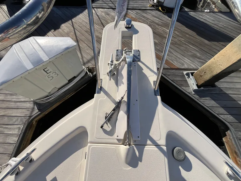 Slide: The Image of 2005 Mainship RumRunner boat deck with anchor and dock view. - 17