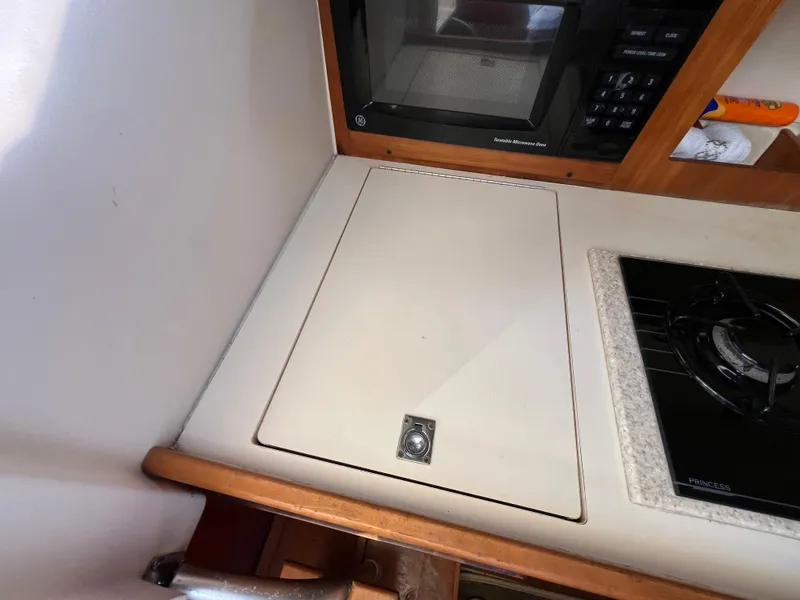 Slide: The Image of 2005 Mainship RumRunner galley with microwave and stove. - 28