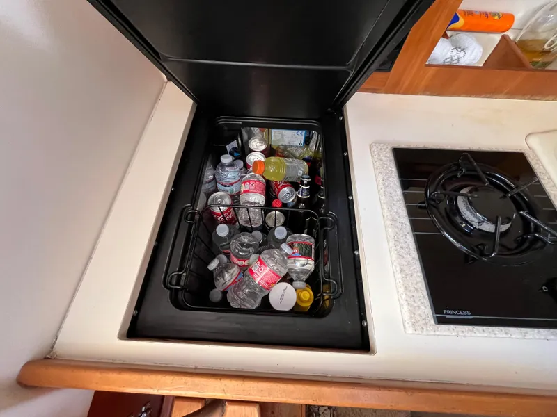 Slide: The Image of Built-in cooler with drinks on 2005 Mainship RumRunner boat kitchen counter. - 29